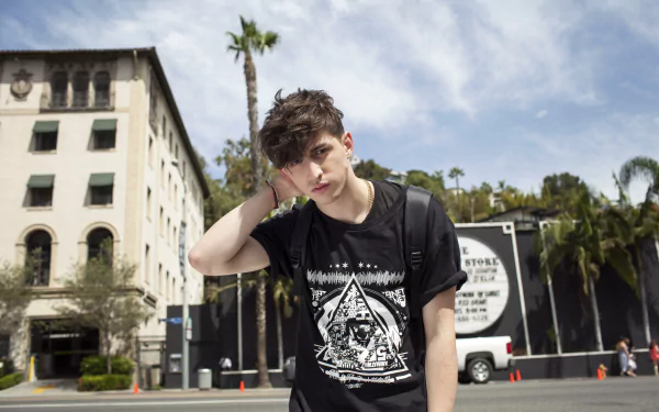 HD wallpaper featuring a young man posing in front of a building with palm trees in the background, tagged as Porter Robinson.