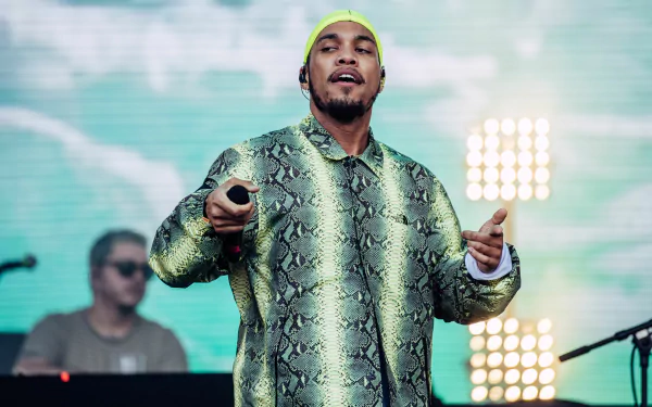 HD desktop wallpaper featuring Anderson .Paak performing on stage with vibrant stage lights in the background.