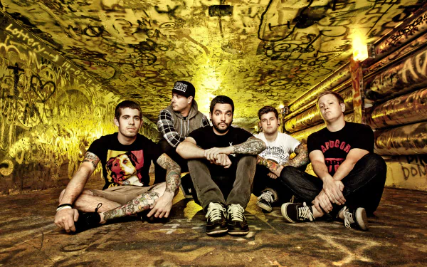 HD desktop wallpaper featuring the band A Day To Remember seated against a graffiti-covered wall.