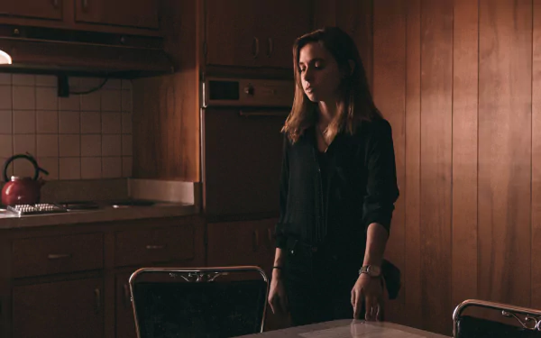 HD wallpaper of a person in a dimly lit kitchen with wooden panels, suited for desktop background, tagged with Julien Baker.