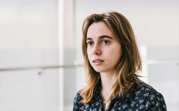 HD desktop wallpaper featuring a contemplative individual in a floral shirt, suitable as a background, tagged with Julien Baker.