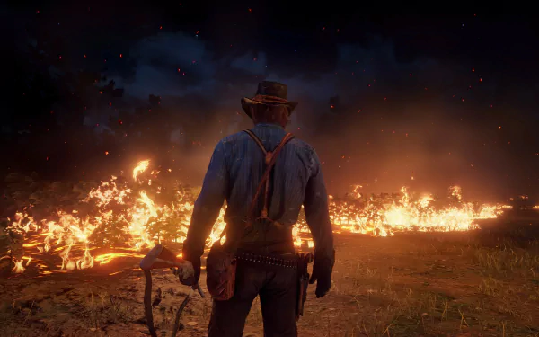 Arthur Morgan from Red Dead Redemption 2 stands before a blazing fire in this intense 4K Ultra HD PC desktop wallpaper.