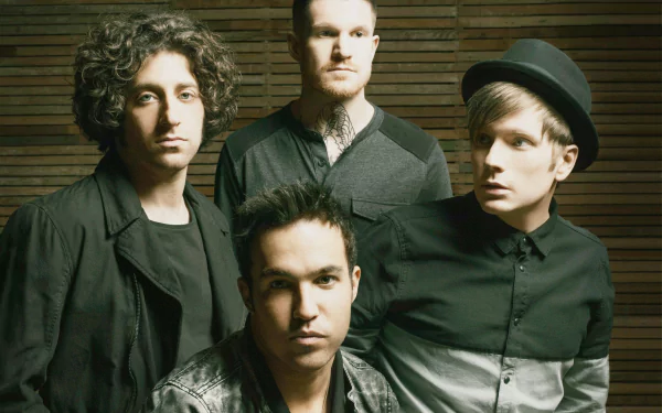 High-definition desktop wallpaper featuring a group of four band members posing against a wooden backdrop, tagged as Fall Out Boy.