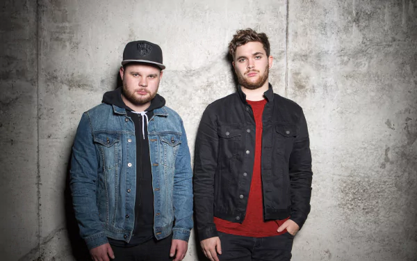 HD desktop wallpaper of two members from Royal Blood posing against a textured grey background.