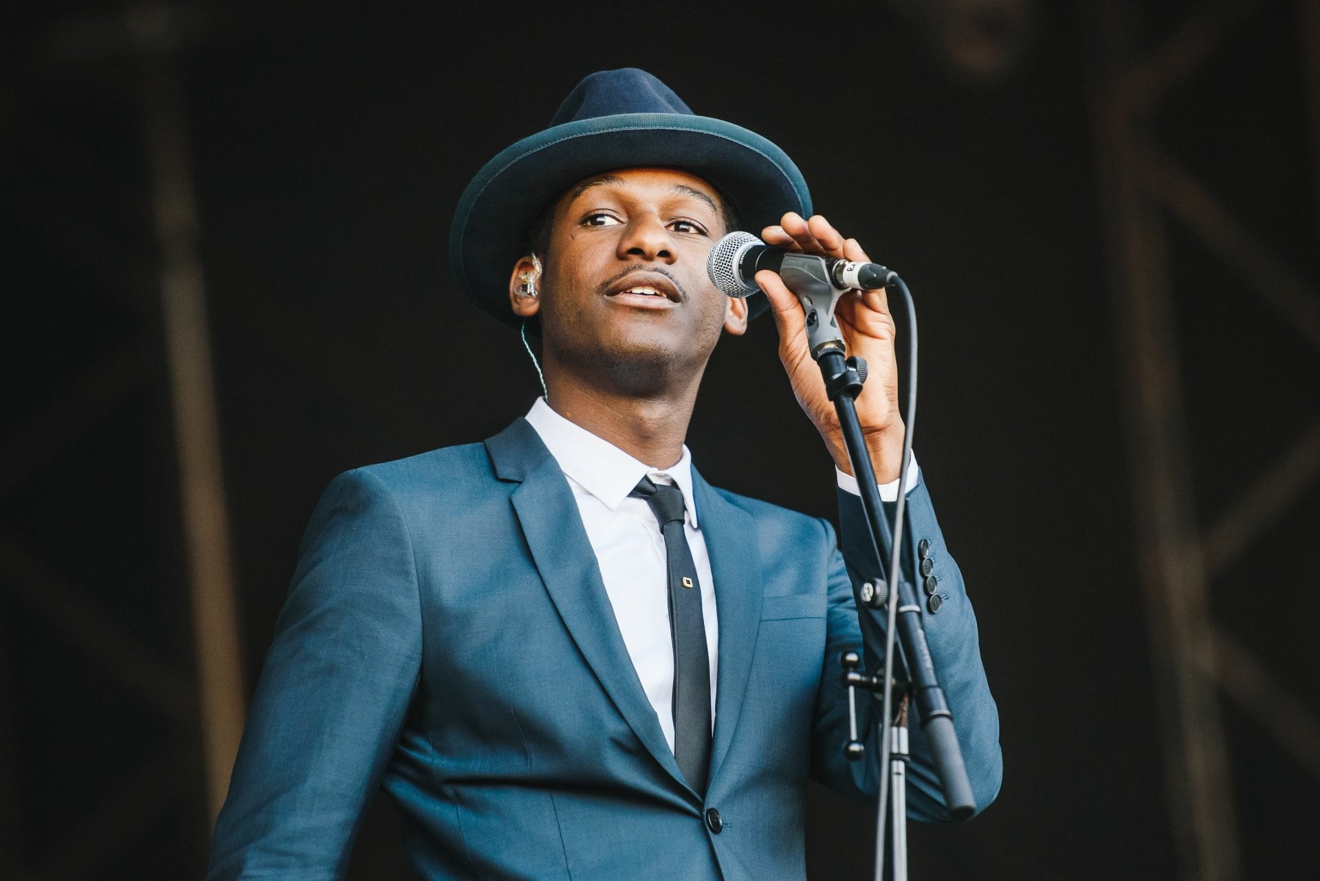 Singer in a blue suit and hat performing on stage, HD desktop wallpaper and background.