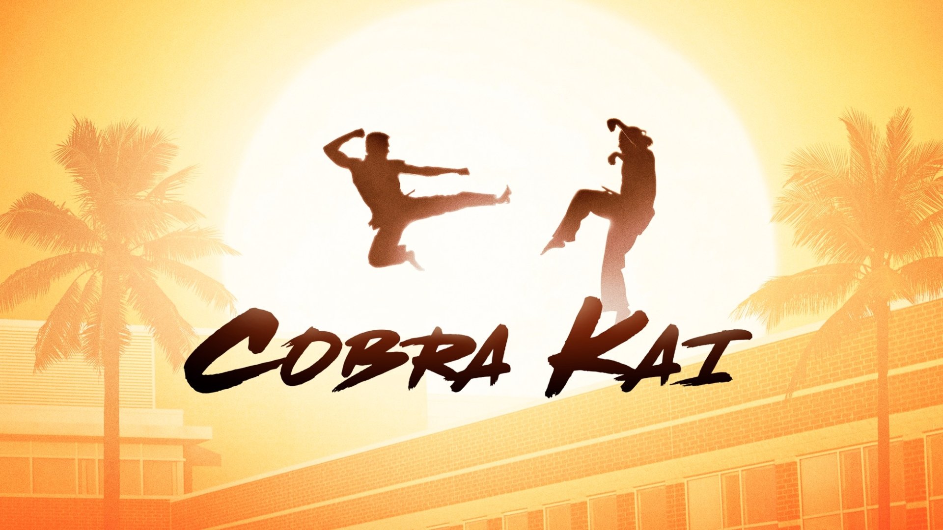 Cobra Kai TV show HD PC desktop wallpaper: two silhouetted fighters kicking before a glowing sun, palm trees and a school in warm sunset hues.