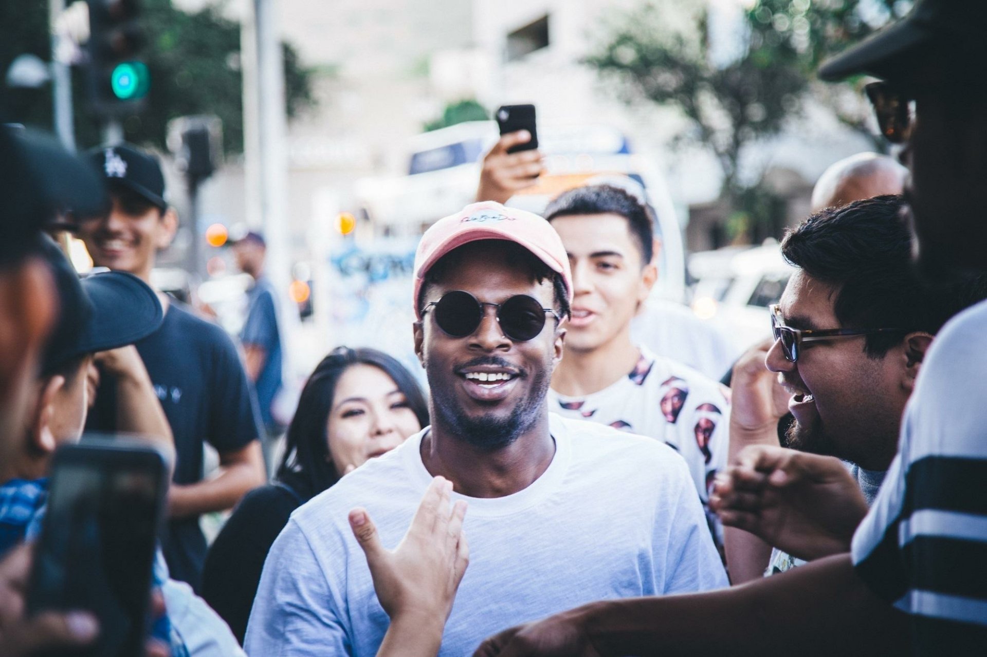 Smiling person in a pink cap with fans, suitable as a HD desktop wallpaper and background tagged with Isaiah Rashad.