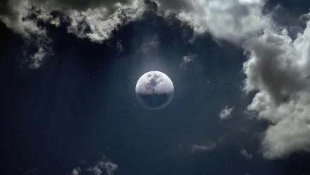 8K Ultra HD PC wallpaper showing the moon partially obscured by clouds under a dark night sky, highlighting nature’s serene and mysterious beauty.
