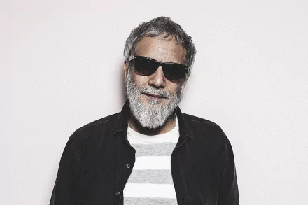 Stylish man with a beard and sunglasses posing for a HD desktop wallpaper background.