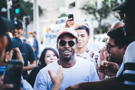 Smiling person in a pink cap with fans, suitable as a HD desktop wallpaper and background tagged with Isaiah Rashad.