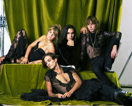 A striking HD desktop wallpaper featuring the band Maneskin, showcasing their unique style and charisma against a vibrant green backdrop.