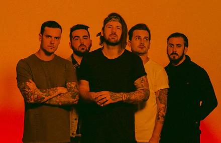 Beartooth band members posing together for an HD desktop wallpaper with an orange background.