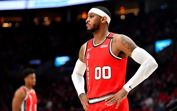 HD desktop wallpaper of a basketball player in a red jersey, ready for action on the court, creating a dynamic background.