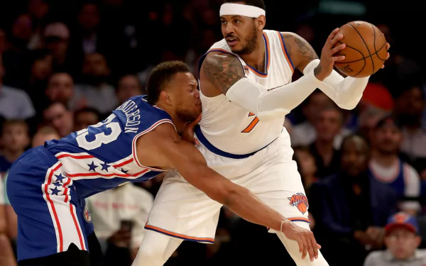HD desktop wallpaper of Carmelo Anthony in action on the basketball court, facing off against an opponent.