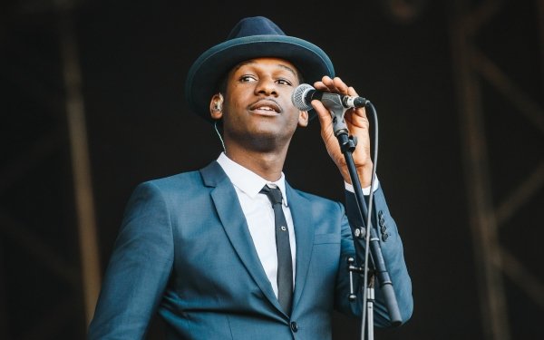 Singer in a blue suit and hat performing on stage, HD desktop wallpaper and background.