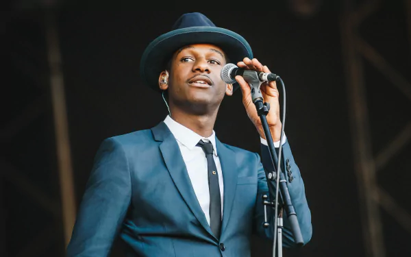 Singer in a blue suit and hat performing on stage, HD desktop wallpaper and background.
