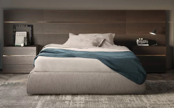 HD desktop wallpaper featuring a stylish bed with neatly arranged pillows and a blue throw blanket in a serene bedroom setting.