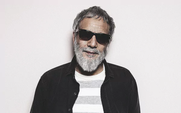 Stylish man with a beard and sunglasses posing for a HD desktop wallpaper background.