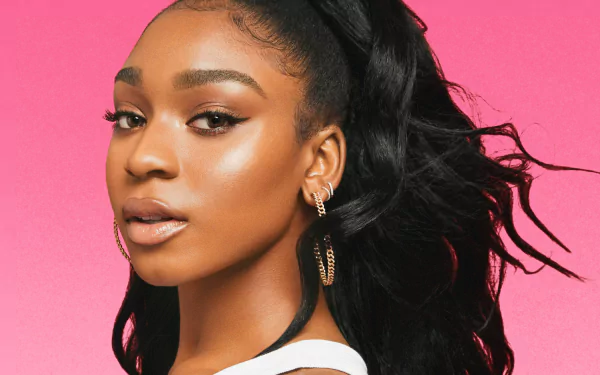 HD desktop wallpaper featuring a close-up portrait of a woman with striking makeup and a stylish ponytail set against a vibrant pink background.