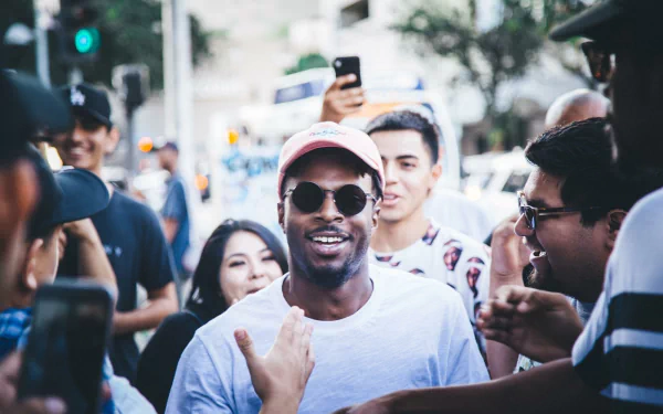 Smiling person in a pink cap with fans, suitable as a HD desktop wallpaper and background tagged with Isaiah Rashad.