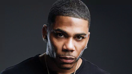 HD desktop wallpaper featuring a close-up of Nelly, the renowned music artist, against a dark background, capturing his intense expression and charisma.