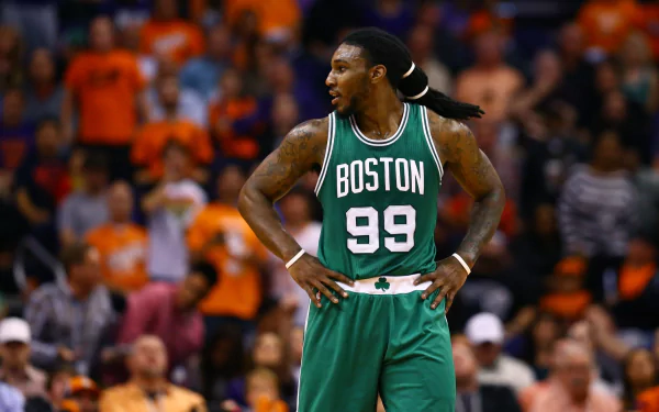 HD desktop wallpaper featuring a basketball player in a Boston jersey number 99 standing on the court, suitable as a background image.