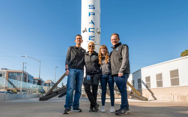 Inspiration4 mission crew posing in front of the SpaceX logo, providing motivation in this high-definition desktop wallpaper.