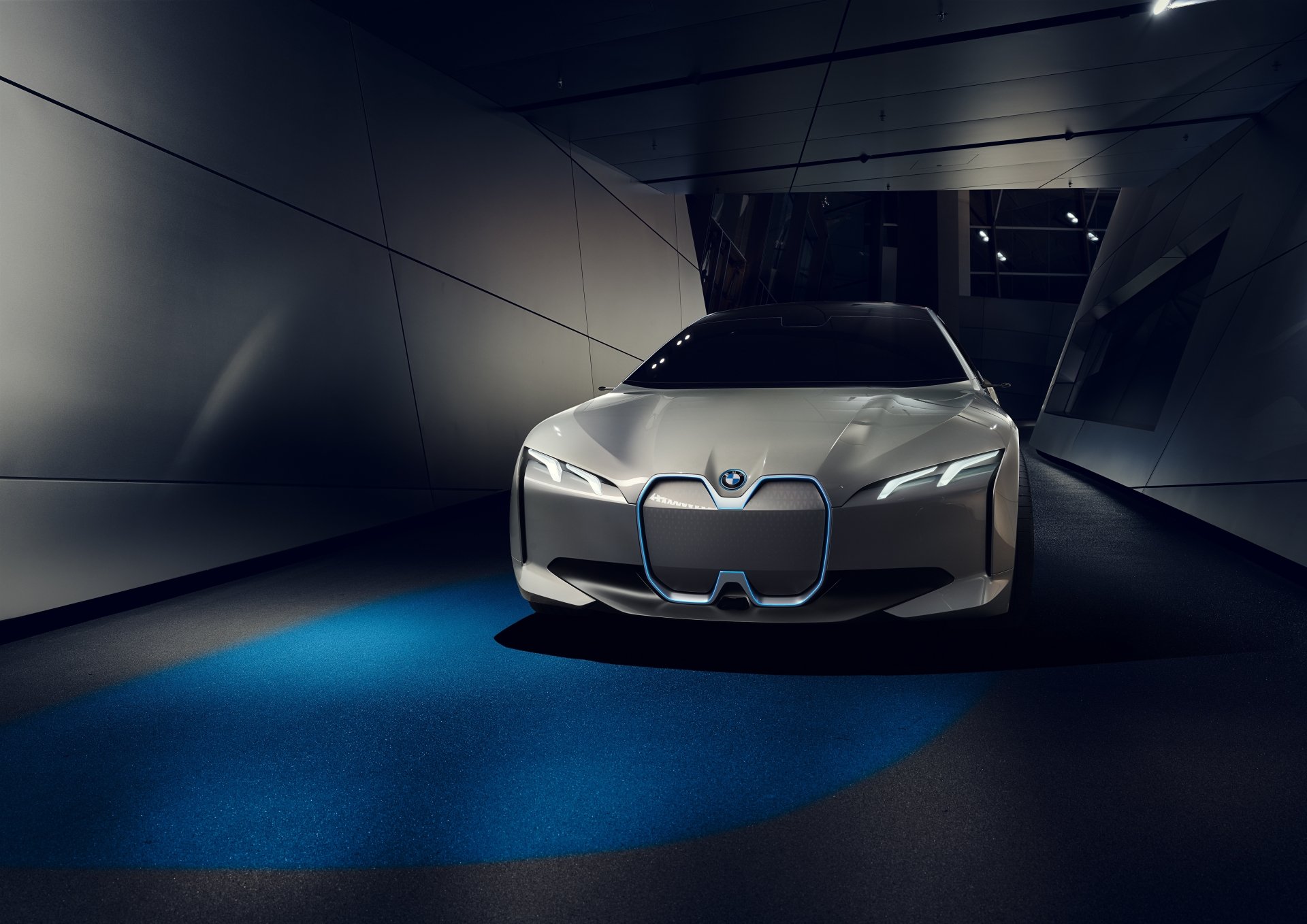 A sleek BMW i Vision Dynamics concept car shines in a modern environment, showcasing its futuristic design as an advanced electric vehicle in this 4K Ultra HD desktop wallpaper.