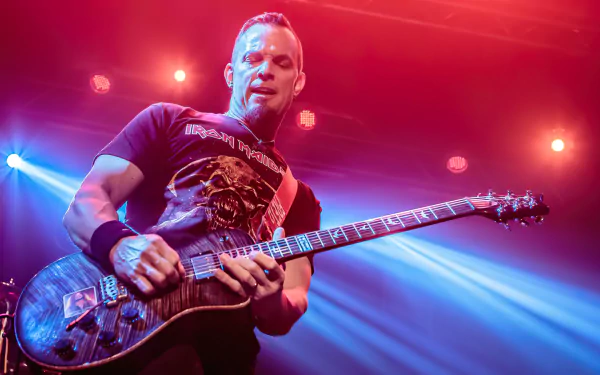 A dynamic image of Tremonti performing on stage, showcasing his guitar skills under vibrant stage lights. This HD wallpaper captures the energy of live music.
