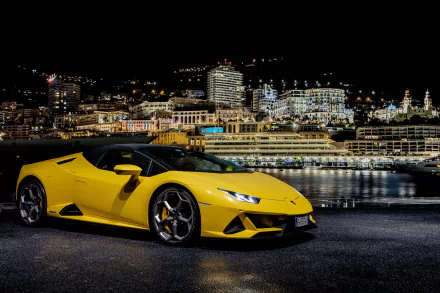 Yellow Lamborghini Huracan Evo supercar parked by a waterfront at night with city lights reflecting, captured in stunning 4K Ultra HD for PC desktop wallpaper.