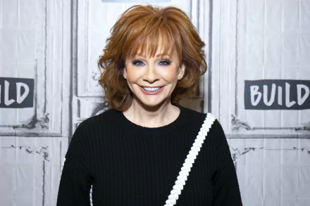 Smiling woman with red hair posing in front of a backdrop with text, providing an elegant HD desktop wallpaper and background.
