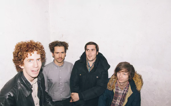 HD desktop wallpaper featuring Parquet Courts, with the band members standing against a white backdrop.