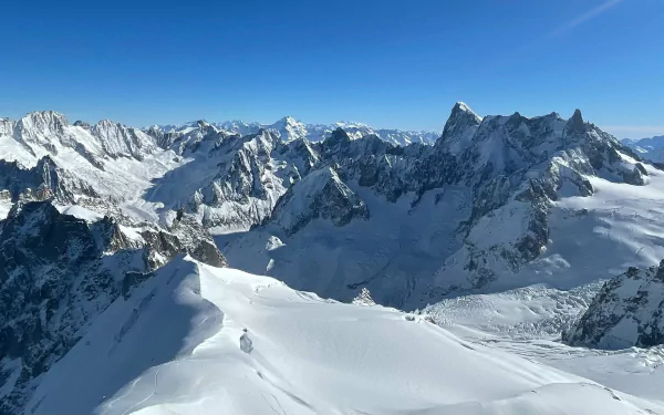 Snow-covered mountain peaks under a clear blue sky, showcasing a stunning natural landscape in this HD PC desktop wallpaper background.