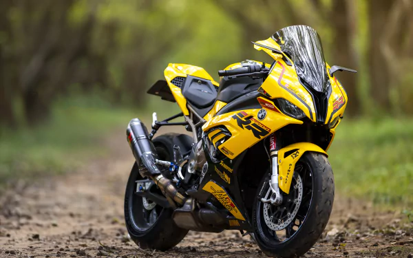 Yellow BMW S1000RR sportbike vehicle (BMW S1000) parked on a forest dirt path — high-detail 5K Ultra HD PC desktop wallpaper background.