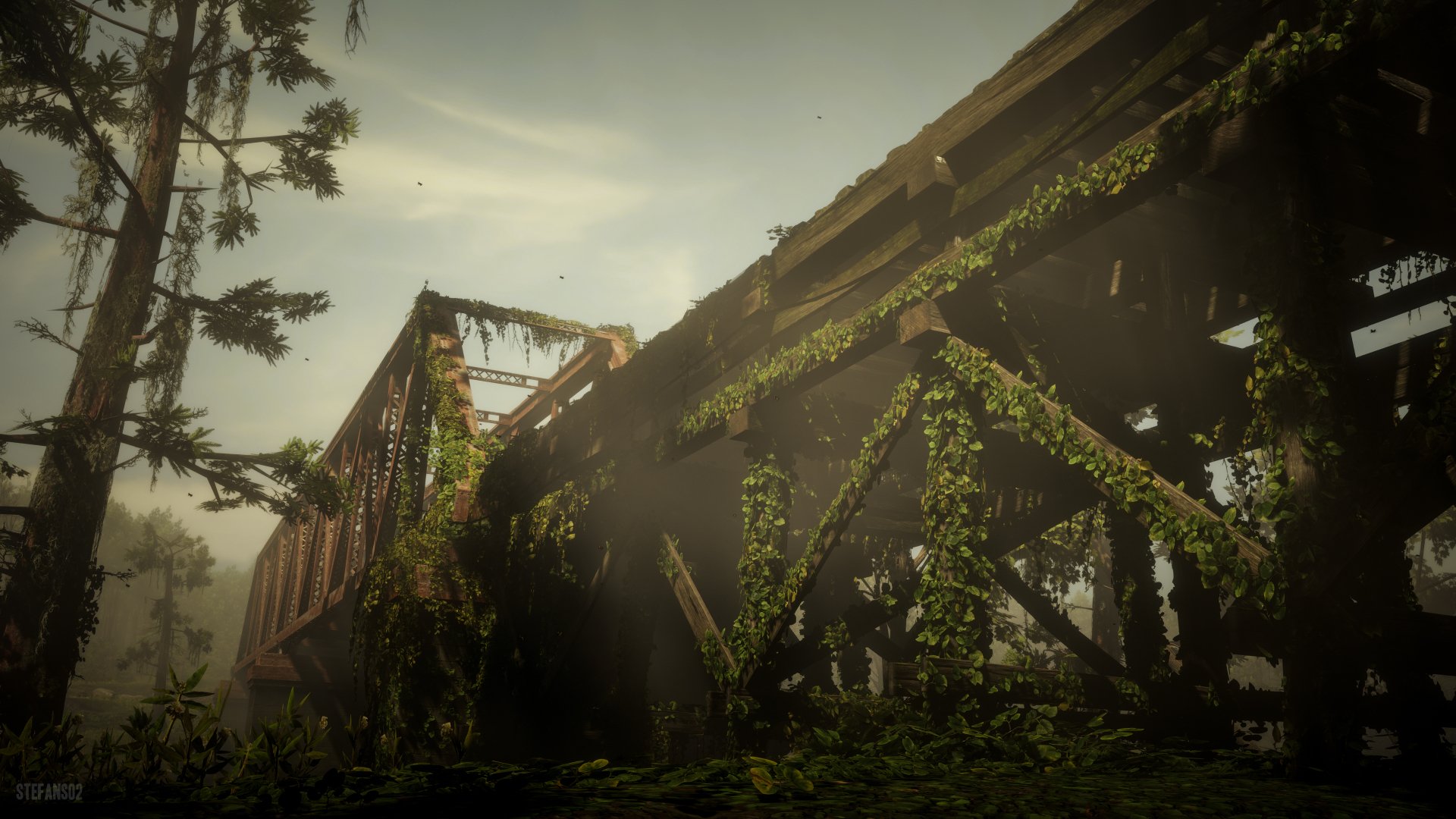 A 4K Ultra HD PC desktop wallpaper from the video game Red Dead Redemption 2, featuring an old, vine-covered iron bridge shrouded in mist and sunlight.