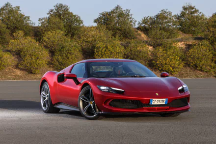 Red Ferrari 296 GTB supercar on pavement with a tree-lined hill behind — 5K Ultra HD PC desktop wallpaper/background