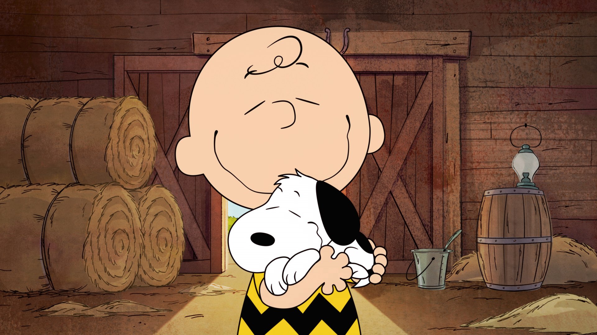 Charlie Brown hugs Snoopy inside a rustic barn, featured in The Snoopy Show, presented as a 4K Ultra HD PC desktop wallpaper.