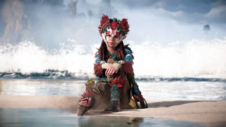 Aloy from Horizon Forbidden West sits on a beach with waves crashing behind her in this 4K Ultra HD PC desktop wallpaper from the Horizon video game series.