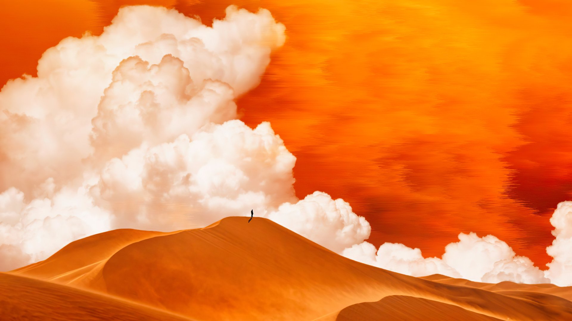 4K Ultra HD PC desktop wallpaper: artistic desert scene of sweeping sand dunes under a fiery orange sky with billowing clouds and a lone tiny silhouette on the dune crest.