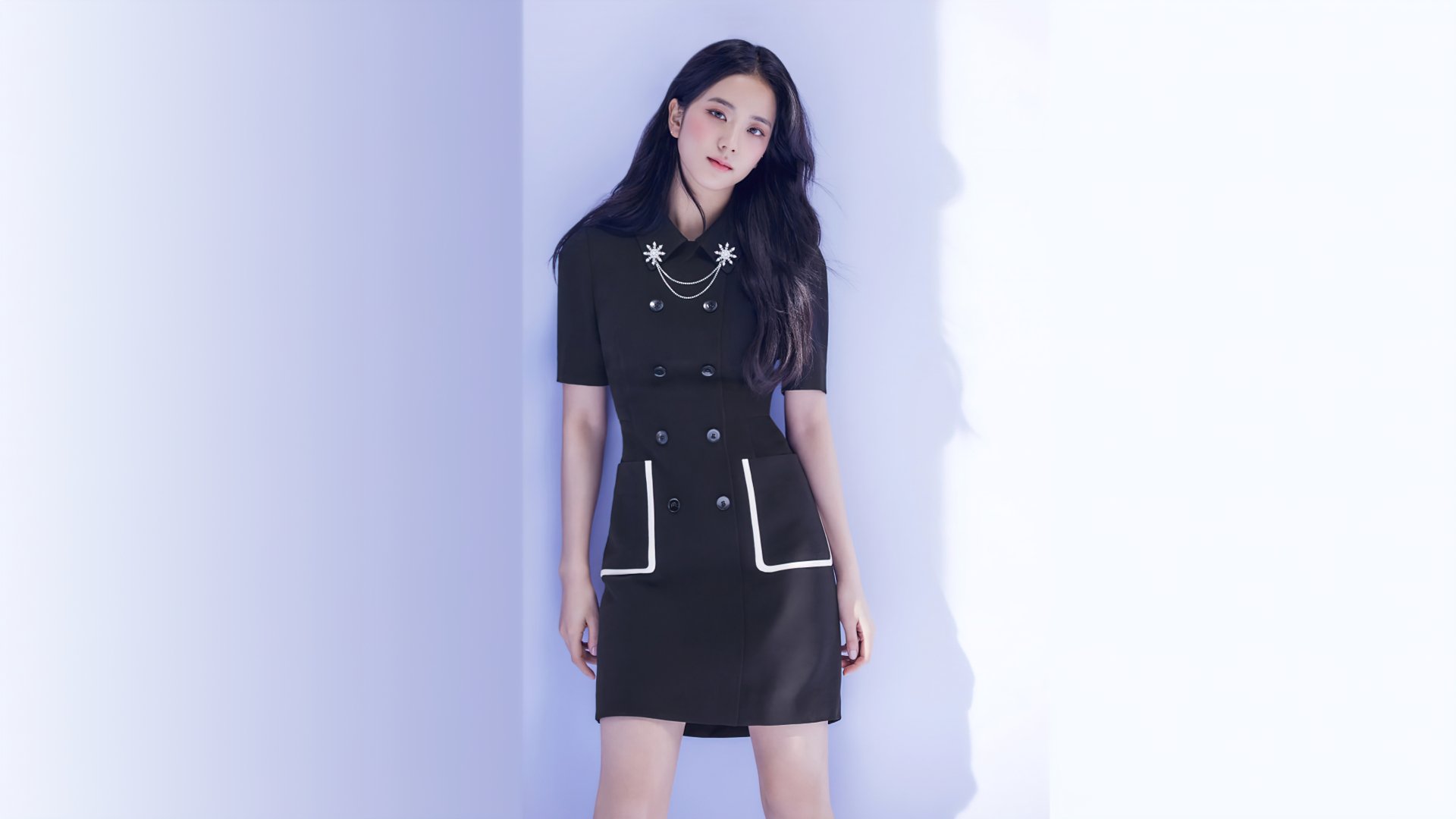 Jisoo from BlackPink poses against a minimalist light background, featured in a sleek black outfit, captured in a 4K Ultra HD music-themed desktop wallpaper.