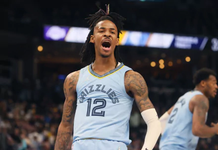 HD PC desktop wallpaper featuring Ja Morant in a Memphis Grizzlies jersey during an intense moment in a basketball game, capturing dynamic sports action.