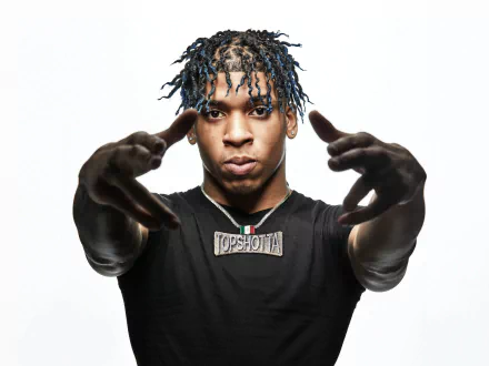 4K Ultra HD PC wallpaper of a hip-hop artist reaching toward the camera, wearing a chain and black tee with an intense gaze—bold, music-themed desktop background.
