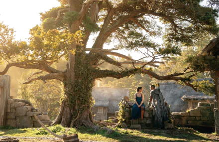 HD desktop wallpaper featuring Arondir (Ismael Cruz Córdova) and Bronwyn (Nazanin Boniadi) from the TV show The Lord of the Rings: The Rings of Power in a sunlit rustic setting.