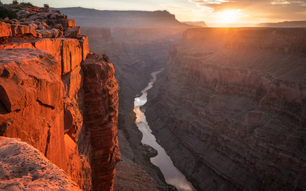 2K Quad HD PC desktop wallpaper and background of a sunlit canyon: red rock cliffs overlooking a winding river through deep shadowed gorges at sunset.