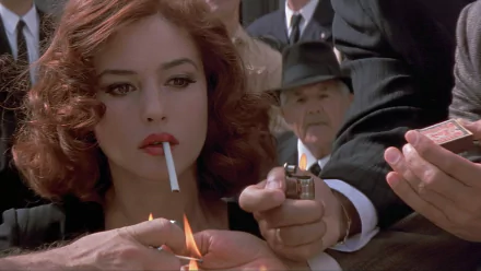 Close-up movie still from Malena (2000): red‑haired woman holding a cigarette while several hands light it — 2K Quad HD PC desktop wallpaper/background.