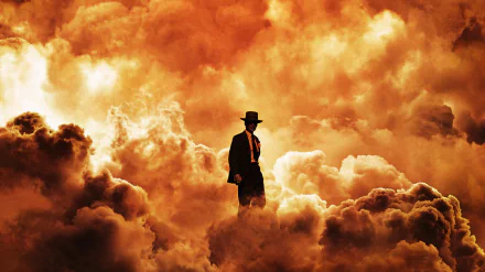 4K Ultra HD desktop wallpaper featuring a dramatic scene from the movie Oppenheimer, showing a lone figure in a suit and hat amidst fiery, billowing clouds.
