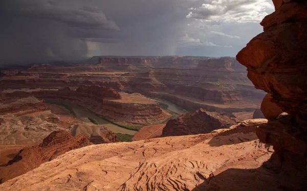 4K Ultra HD image showcasing the vast natural beauty of the Grand Canyon, USA, with dramatic skies over rugged canyon terrain.