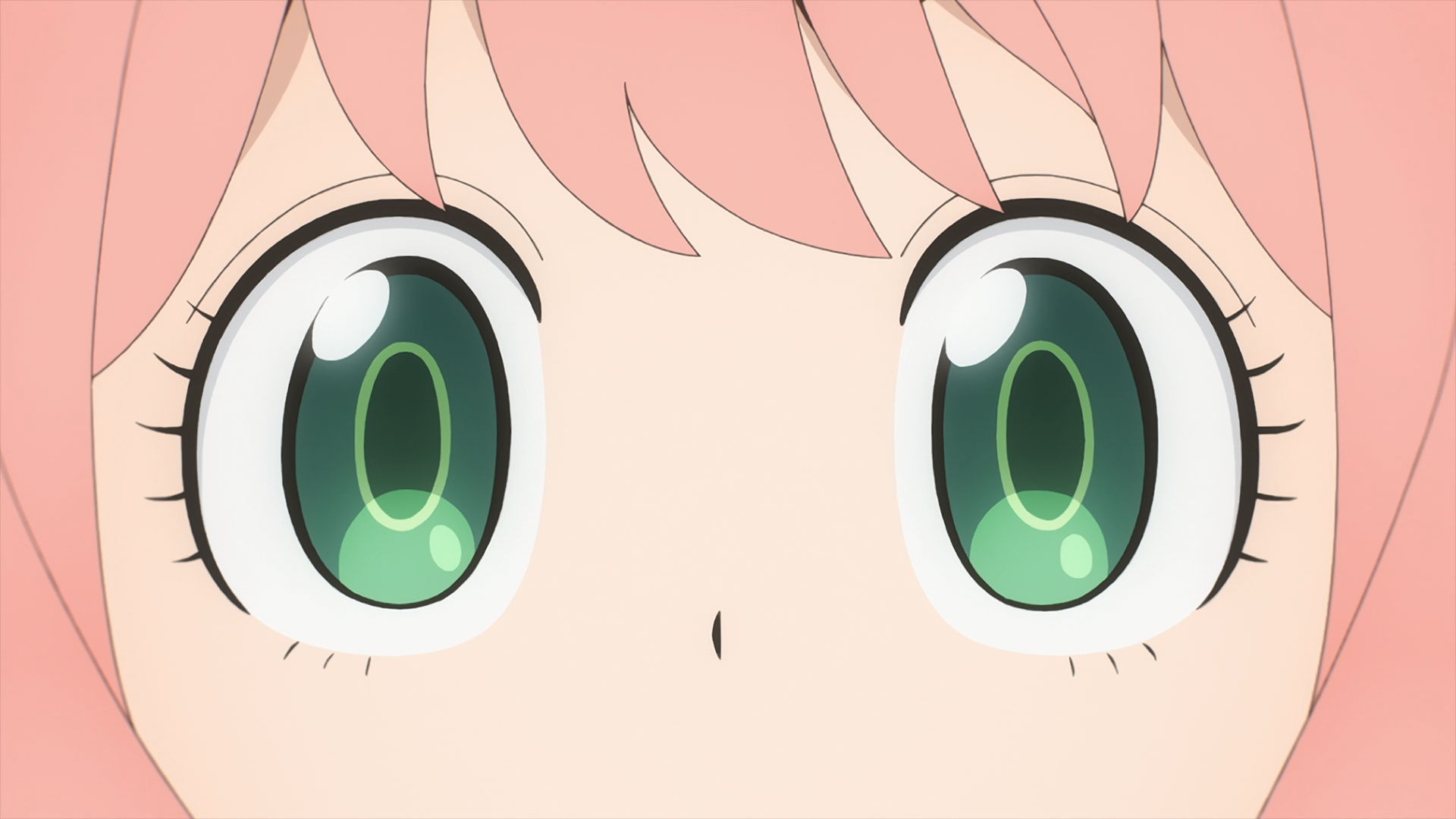 Close-up of Anya Forger's wide green eyes and pink hair from Spy x Family, HD anime PC desktop wallpaper/background.