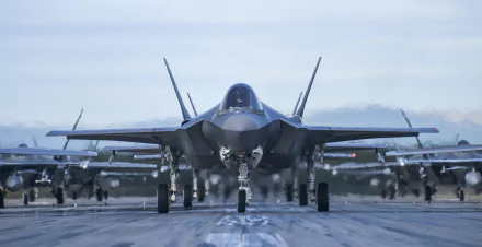 Lockheed Martin F-35 Lightning II military jets lined up on a runway, shown in sharp detail for a 4K Ultra HD PC desktop wallpaper and background.