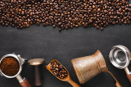 HD PC desktop wallpaper featuring scattered coffee beans, ground coffee, and vintage coffee-making tools arranged on a dark textured background.